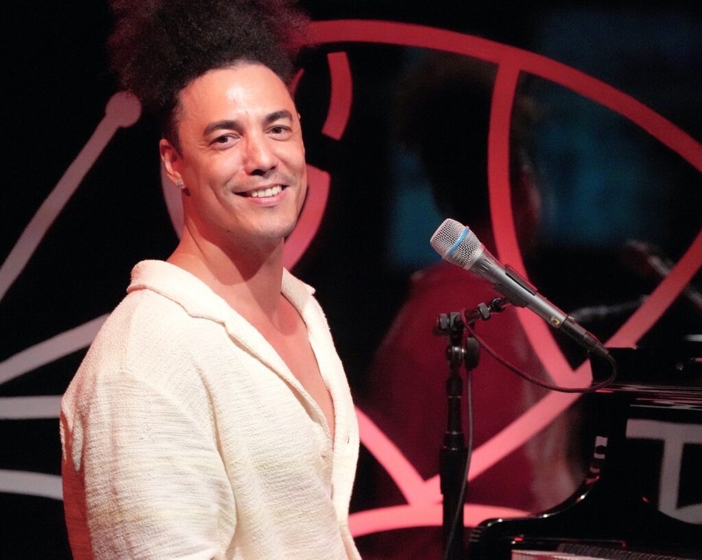 Pianist Jorge Luis Pacheco smiling at the piano
